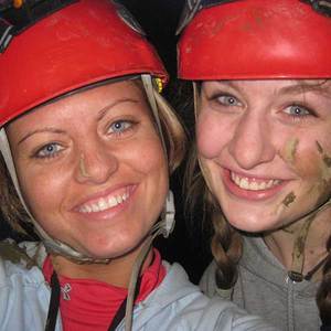 faces of two girls in underground adventure cave trip