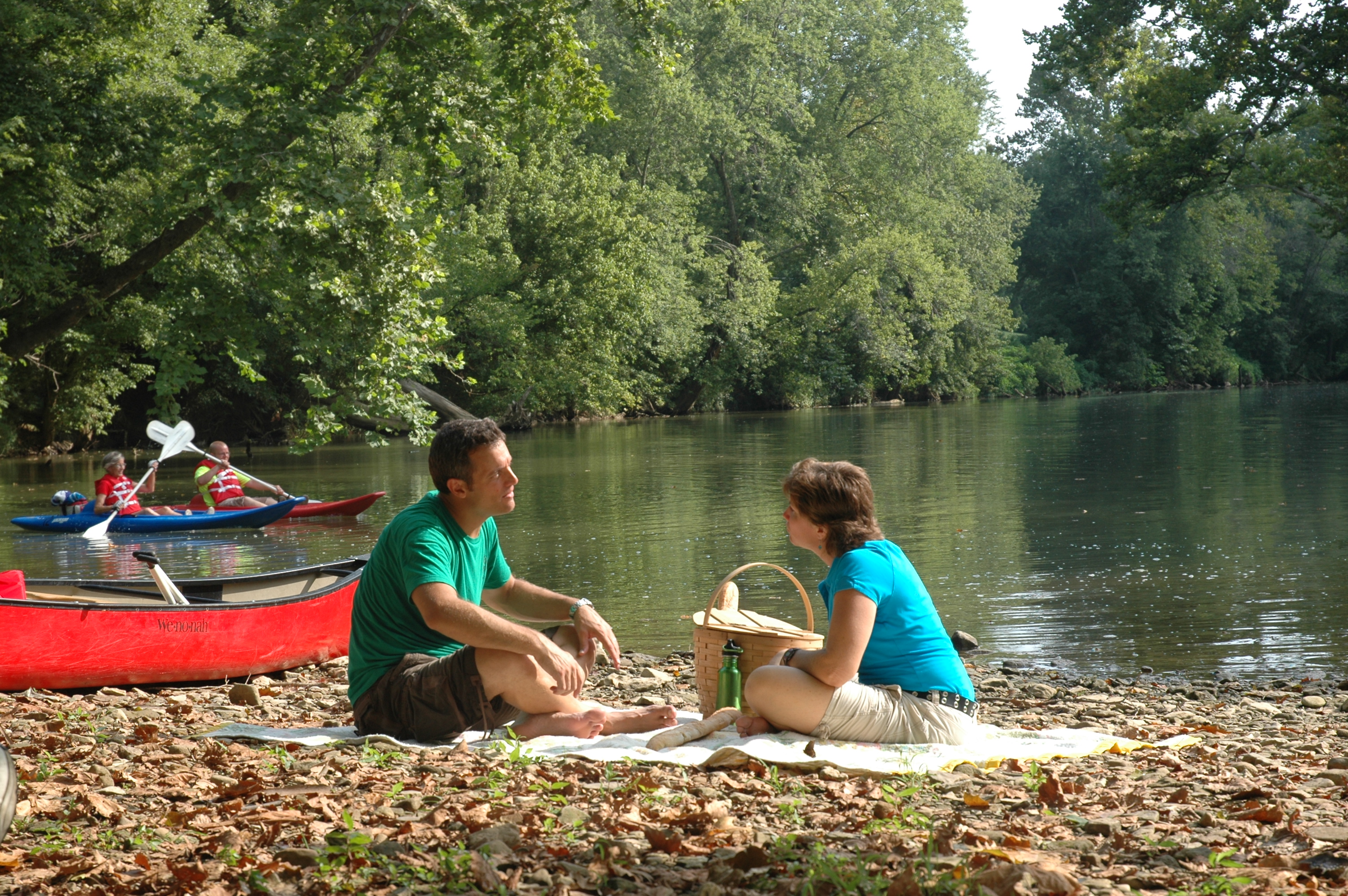 couple canoeing and having a picnic on Blue River at Cave Country Canoes